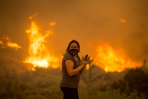 A woman watches as the Bobcat Fire burns in Juniper Hill, Calif., Friday, Sept. 18, 2020. Photo by Ringo H.W. Chiu-Photojournalist 