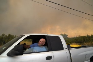 Shane Allen sits in his truck after the Bobcat fire forced him to evacuate Friday, Sept. 18, 2020, in Juniper Hills, Calif. (AP Photo/Marcio Jose Sanchez)
