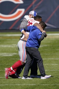 New York Giants running back Saquon Barkley is helped off the field after being injured against the Chicago Bears during the first half of an NFL football game in Chicago, Sunday, Sept. 20, 2020. Photo by Charles Rex Arbogast-Photojournalist