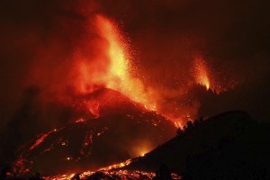 Lava flows from an eruption of a volcano near El Paso on the island of La Palma in the Canaries, Spain, Sunday, Sept. 19, 2021. Lava continues to flow slowly from a volcano that erupted in Spain’s Canary Islands off northwest Africa. The head of the islands' regional government says Monday he expects no injuries to people in the area after some 5,000 were evacuated. (Europa Press via AP)