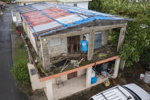 Aerial view of a woman standing in her house Puerto Rico which was previously damaged by Hurricane Maria. 