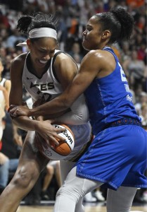 Las Vegas Aces' A'ja Wilson, left, is pressured by Connecticut Sun's Alyssa Thomas, right, during the first half in Game 4 of a WNBA basketball final playoff series, Sunday, Sept. 18, 2022, in Uncasville, Conn. (AP Photo/Jessica Hill)