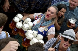 A women carries glasses of beer to serve at the festival in Germany. 