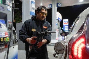An attendant prepares to fill a customer’s tank at a gas station on Wednesday, May 6, 2026 in Portland, Ore. (AP Photo/Jenny Kane)