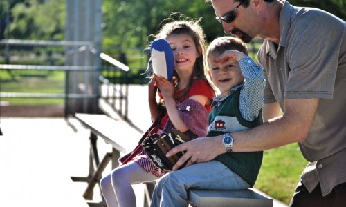 Summer sports are nearing: Mark Baskin and his children Emma (left) and Ben (right) catch a CLU baseball game.
Photo by Lauren Rote - Staff Photographer