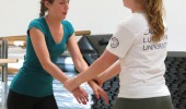 Reflection: Sophomore Grace Stepien (left) and junior Rebekah Peterson (right) practice their newly-learned techniques to break free from an attacker.  
Photos by Debben Hoffer- Staff Photographer
