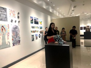 Senior Hallie Maxwell discusses her art at a walk-through of “Natural Conditions,” an exhibit assembled by the art capstone class, on May 3. Photo by Lindsey Potter- Reporter.